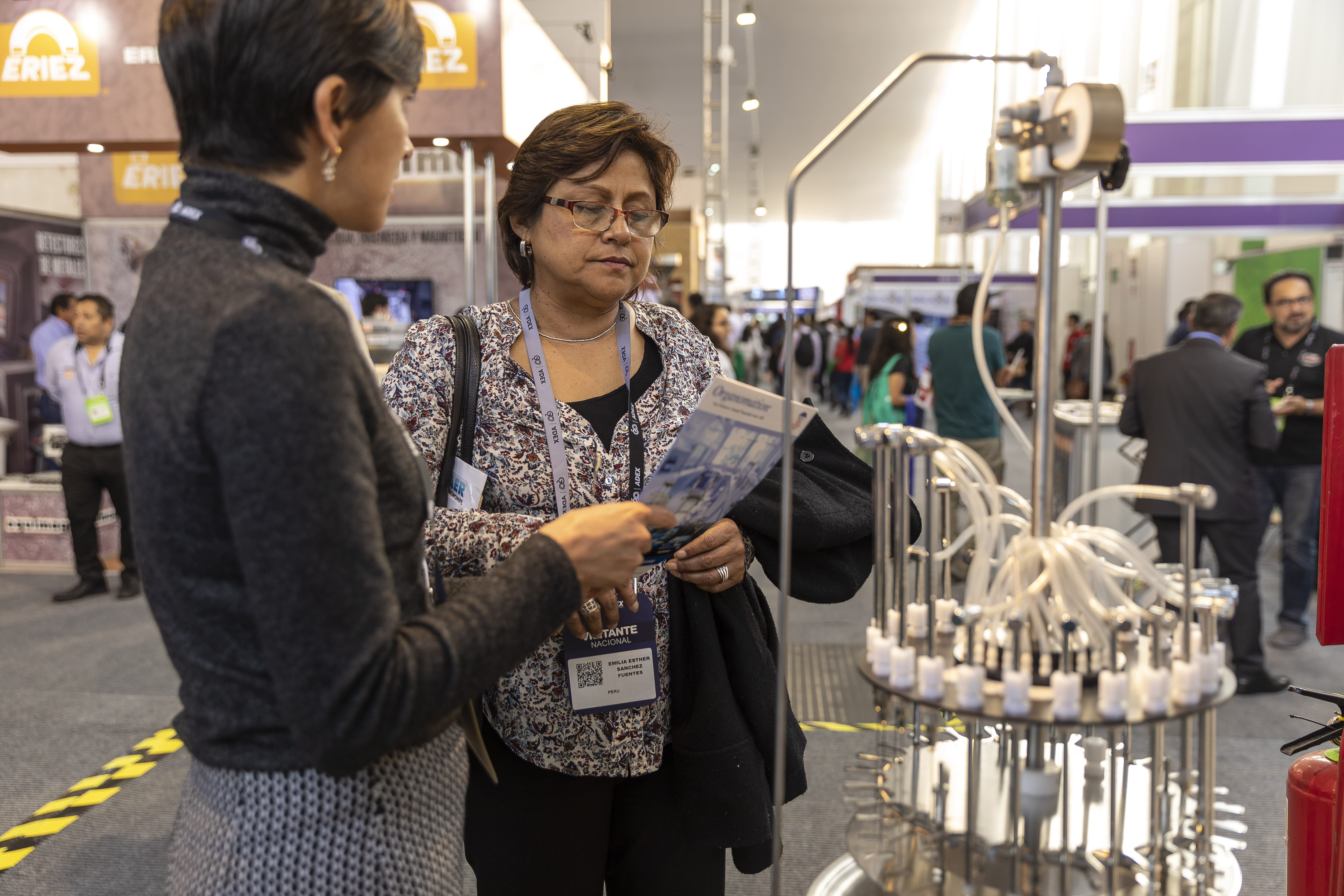 Sulabsa's General Manager, Paola Cueva, showing Organomation product catalog to Expoalimentaria Fair atendee