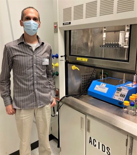 Facility Director of MD Anderson standing next to their MULTIVAP Nitrogen Evaporator