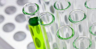 Test tubes in sample rack filled with green solvent 