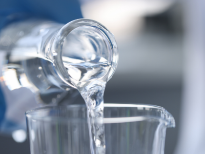 Clear solvent being poured into glassware